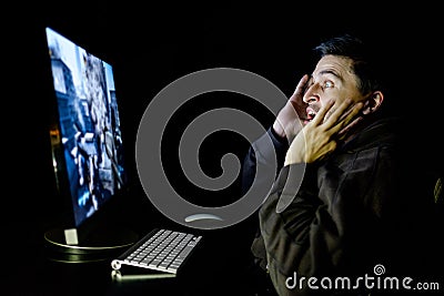 Angry young gamer playing videogame Stock Photo