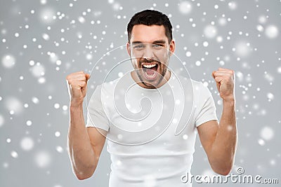 Angry young man holding fists over snow Stock Photo