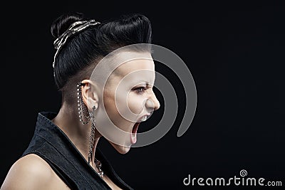 Angry young woman screaming isolated on black background Stock Photo