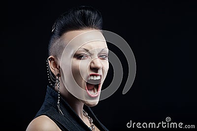 Angry young woman screaming isolated on black background Stock Photo