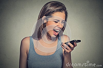 Angry young woman screaming on mobile phone Stock Photo
