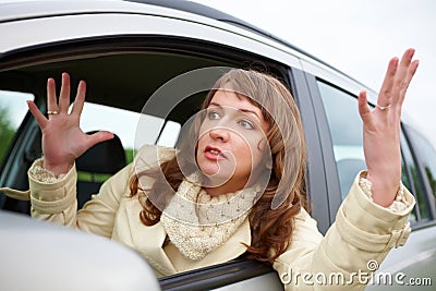 Angry young woman sitting in a car Stock Photo