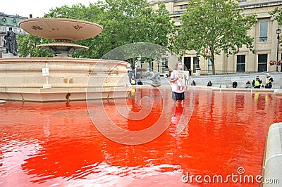 Animal rights activists turn Trafalgar Square fountains in London blood red Editorial Stock Photo