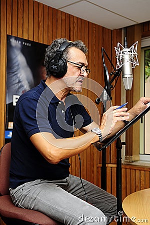 Animation Voice Actor in Recording Booth_Radio Box Editorial Stock Photo