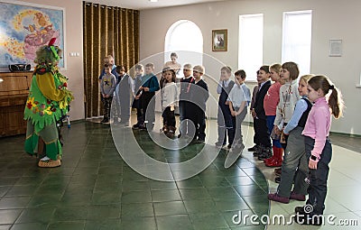 Animator in a costume Of a Kikimora Bolotnaya plays with children Editorial Stock Photo