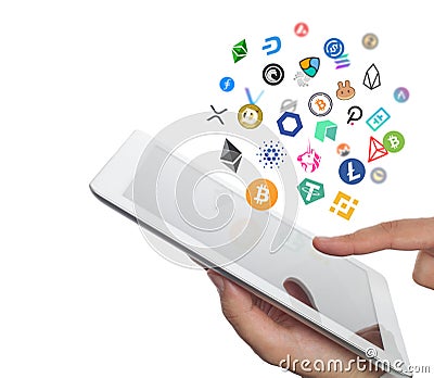 Bitcoin, ethereum and other coin icons flying over the ipad screen in hand of trader on white background Editorial Stock Photo