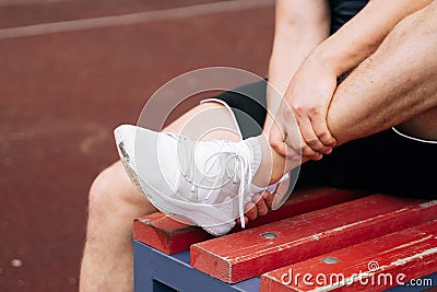 Ankle dislocation by a male athlete.Concept of a sports soccer coach breaking an ankle on a soccer field during training Stock Photo