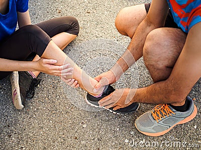 Ankle sprained. Young woman suffering from an ankle injury while Stock Photo