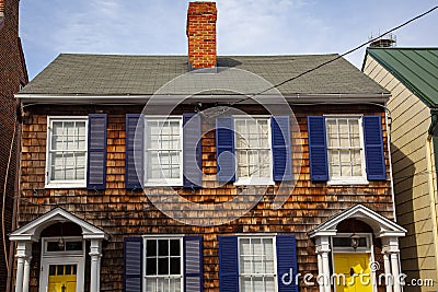 A vintage semidetached house with wooden tile exterior Editorial Stock Photo