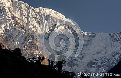 Annapurna South snowcapped mountain summit and glacier against blue sky Stock Photo