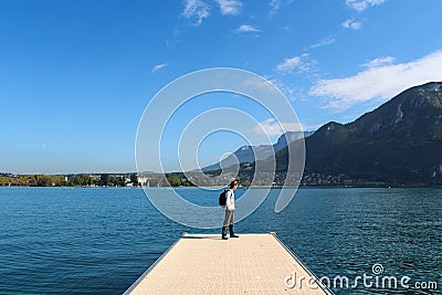 ANNECY, FRANCE - SEPTEMBER 22, 2012: Tourist walks on the pier Editorial Stock Photo