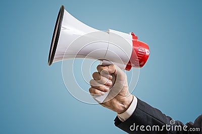 Announcement concept. Hand holds megaphone Stock Photo