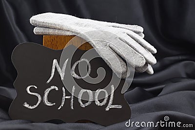 NO SCHOOL sign on chalkboard against black satin warns of cold w Stock Photo