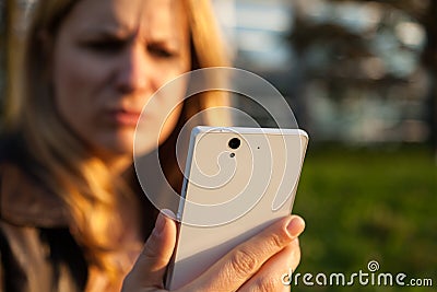 Annoyd woman with smartphone Stock Photo
