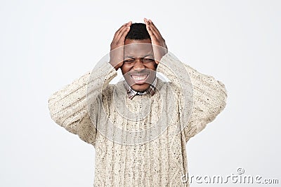 african american man in sweater in panic, shocked to hear bad news. Stressful situation concept Stock Photo