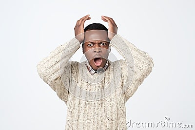 american man in sweater in panic, shocked to hear bad news. Stressful situation concept Stock Photo