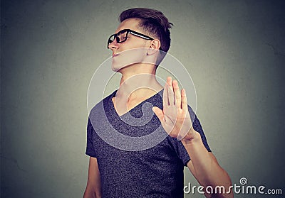 Annoyed angry man with bad attitude giving talk to hand gesture Stock Photo