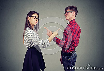 Annoyed angry man and woman facing relationships problems, pointing fingers each other blaming for mistakes Stock Photo