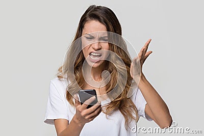 Annoyed angry woman mad about stuck phone isolated on background Stock Photo