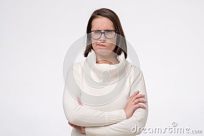 Annoyed caucasian woman keeping arms crossed having sceptical and distrustful look Stock Photo