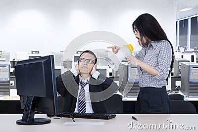 Annoyed employee with her manager in the workplace Stock Photo