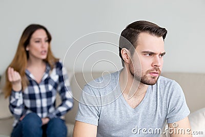 Annoyed husband tired of wife lecturing and arguing Stock Photo