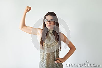 Annoyed indignant housewife, raises her hands into fists, shows strength, comic, joke. wears round transparent glasses Stock Photo