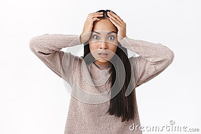 Annoyed and pressured, distressed fed up asian girlfriend tired constantly saying same things, grab head bothered, stare Stock Photo