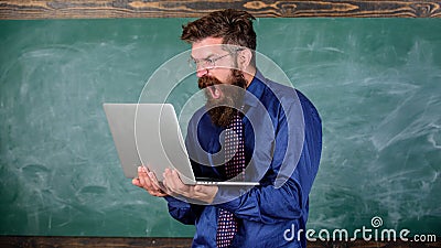 Annoyed by slow internet. Slowly internet annoying him. Teacher bearded man modern laptop chalkboard background. Hipster Stock Photo