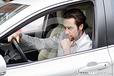 Annoyed tired young man riding driving car. Businessman late for meeting Stock Photo