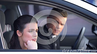 Annoyed woman looking out of car window, upset after quarrel with man, divorce Stock Photo