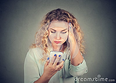 Annoyed woman, off by what she saw on her cell phone Stock Photo