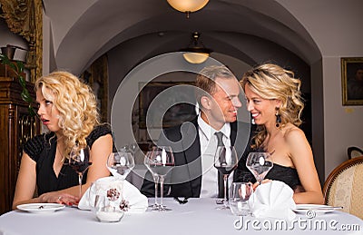 Annoying sweet couple getting on their friends nerves Stock Photo