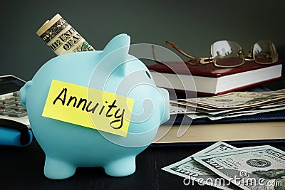 Annuity written on yellow sheet and piggy bank. Stock Photo