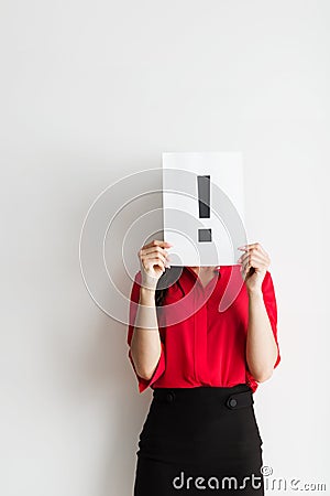 Anonymous business woman holding an exclamation marker Stock Photo