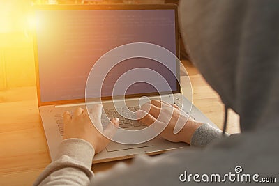 Anonymous computer programmer or hacker working typing on laptop Stock Photo