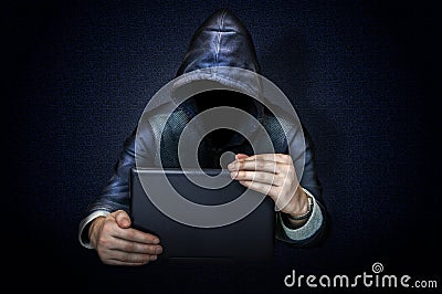 Anonymous hacker with laptop Stock Photo