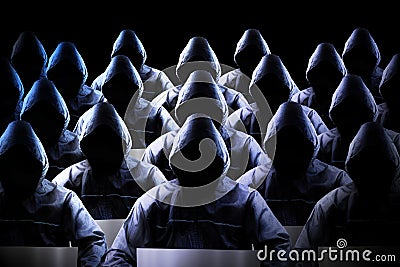 Anonymous hooded hackers, black background, binary code - cyber attack concept Stock Photo