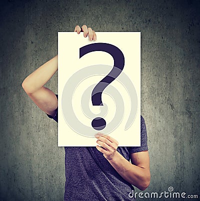 Anonymous man covering face with question mark Stock Photo