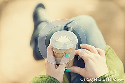 Anonymous woman enjoying takeaway coffee cup on sunny cold fall day Stock Photo