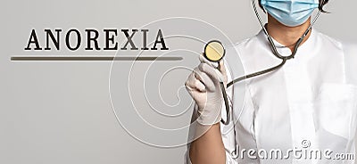 ANOREXIA - concept of text on gray background. Nearby is a doctor in white coat and stethoscope Stock Photo
