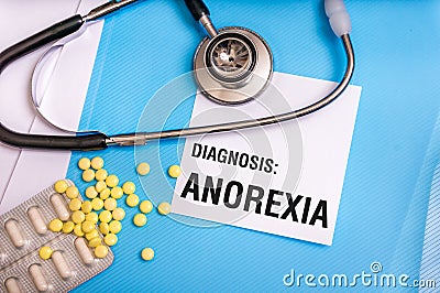 Anorexia word written on medical blue folder with patient files Stock Photo