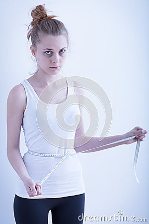 Anorexic girl with measuring tape Stock Photo