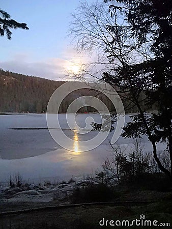 Another amazing frozen lake of the northern way under a full moon Stock Photo