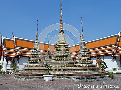 Wat Pho Thai Massage School Service Center. Another attraction of Wat Pho. Chinese stone statues adorned by arches and places. Stock Photo