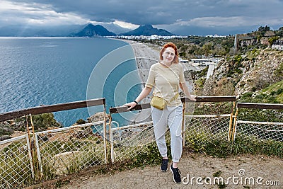 Antalya in spring in March, young woman stands at observation point over Mediterranean Sea. Stock Photo