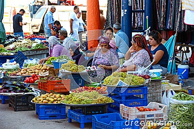 ANTALYA, TURKEY - Aug 14 2012, View of a traditional street markets where old and young women selling fruit and vegetables and tal Editorial Stock Photo
