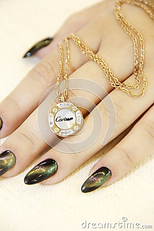 Antalya, Turkey, August 25, 2022. Women`s jewelry precious gold pendants on a chain around the neck Editorial Stock Photo