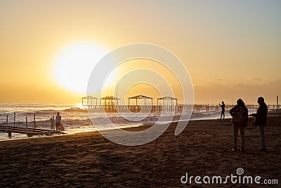 Antalya, Turkey - December 15, 2019: View from beach to water of sea, waves with white foam and black silhouette of person in a Editorial Stock Photo