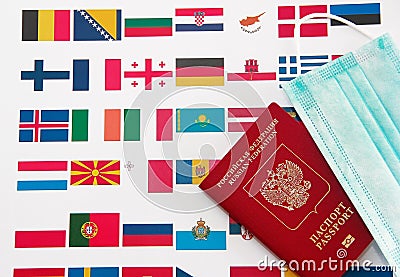 Antalya, Turkey, January 26, 2021. International Russian passport, medical masks and flags of European countries Editorial Stock Photo